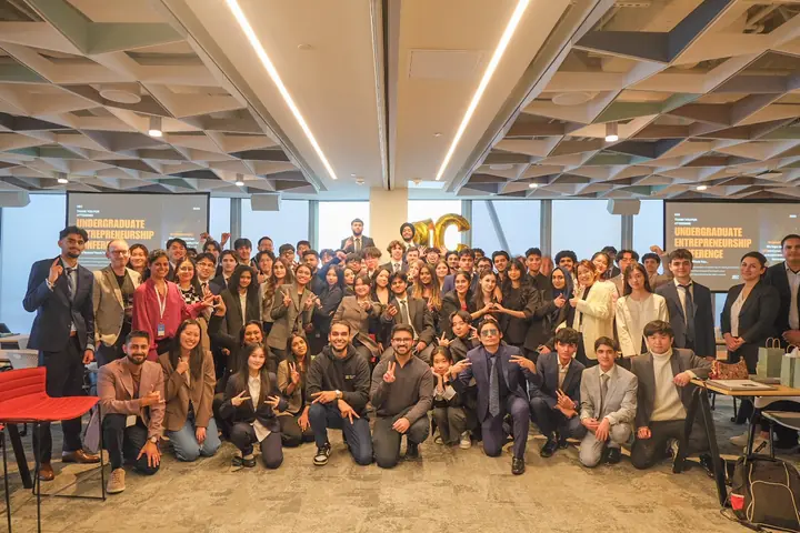 About sixty students and staff posed together at UEC 2025.